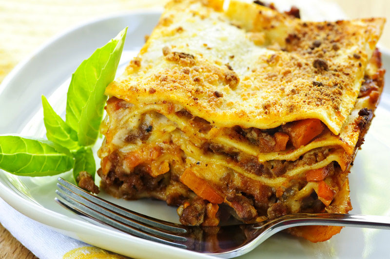 Serving of fresh baked lasagna on a plate -- © Can Stock Photo Inc