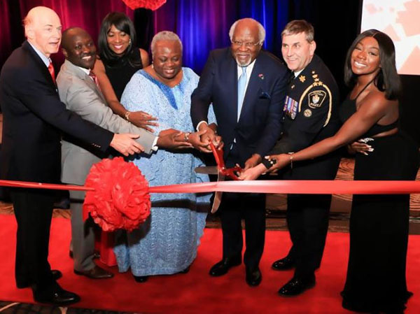 (Left to right): Dr. Tony Ruprecht, former Ontario minister of Multiculturalism; Moses A. Mawa, CEO, Afroglobal TV; Patricia Mawa, Executive Vice President, Afroglobal; Mrs. Gladys Atawo, former board chair, Afroglobal; Dr. Julius Garvey, son of the legendary Marcus Garvey; Eric Jollife, York Regional Police Chief; and Caroline Alabi, Managing Director, Jodal Healthcare, cuts the ribbon at the Afroglobal launch reception on April 29 at Sheraton Hotel, in Toronto.