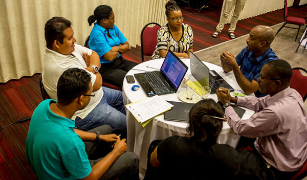 Workshop participants from CRFM Member States seen in discussion in Suriname. Photo credit: CFRM.