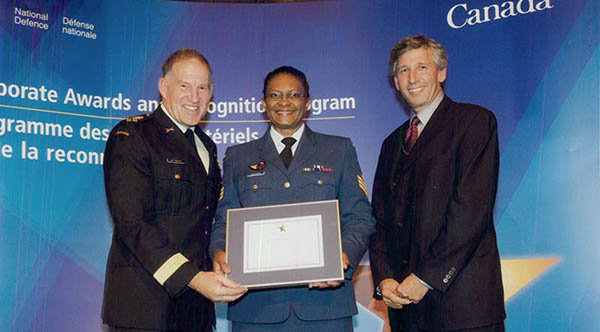 Joan Buchanan receiving her Corporate Award in Human Resource Management in Ottawa, Ontario in 2009 from General Walter Natynczyk, then-Chief of the Defence Staff and former Deputy Minister of Defence Robert Fonberg. Photo credit: ©2009 DND/MDN Canada.