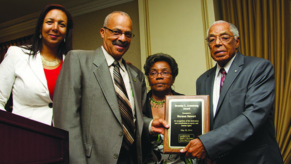 Marie Clarke Walker (left) seen with, from left to right, Herman Stewart, June Veecock and Bromley Armstrong. The foursome was photographed, in May 2014, at an event, where Stewart had received the Bromley L. Armstrong award that was initiated by the Toronto & York Region Labour Council. Clarke Walker was the emcee at the event. Photo contributed.