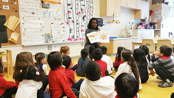 Education Minister Hunter says she tries to visit one Ontario school a week. Here she is seen leading students in a reading excercise.