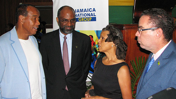 Business magnate and philanthropist, Michael Lee Chin (left), converses with (from left to right): Earl Jarrett, the moderator of the Diaspora Growth Forum; an unnamed member of the audience; and Daryl Vaz, Minister without Portfolio in the Ministry of Economic Growth and Job Creation. Photo credit: Michael Van Cooten.