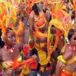 Carnival Masqueraders in Trinidad and Tobago. Photo credit: Jean-Marc /Jo BeLo/Jhon-John from Caracas, Venezuela - 09-Oranges, CC BY 2.0.
