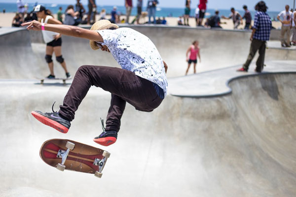 A group of teenagers skateboarding at a local rink. Photo credit: Kirk Morales/Unsplash.