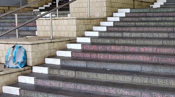 Articles from the UN’s Declaration on Human Rights are seen chalked on a staircase. Photo credit: (University of Esssex/Flickr), CC BY.