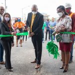 Guyana's Minister of Public Works, Bishop Juan Edghill, cuts the ribbon with General Manager of GTT’s Mobile Money, Bobita Ram and other GTT representatives at the commissioning of the automated tolling system. Photo credit: GDPI.