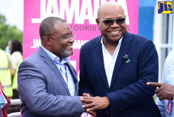 Minister of Tourism, Edmund Bartlett (right), greets Chairman of InterCaribbean Airways, Lyndon Gardiner, at a ceremony, last Thursday, to welcome the first scheduled international flight into the Ian Fleming International Airport in St. Mary. The airplane was an InterCaribbean Airways Embraer120. Photo credit: Adrian Walker/JIS.
