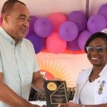 Jamaica's Health and Wellness Minister, Dr. Christopher Tufton (left), presents Deputy Director, Nursing Services (Acting), Bellevue Hospital, Trecia Williams Morrison, with the ‘Staff Excellence Award’, in recognition of her outstanding contribution, during the institution’s Staff Wellness Day and Awards ceremony, yesterday. The event, held at the hospital’s Windward Road address in St. Andrew, formed part of activities for National Healthcare Workers Appreciation Month. Photo credit: Michael Sloley/JIS.