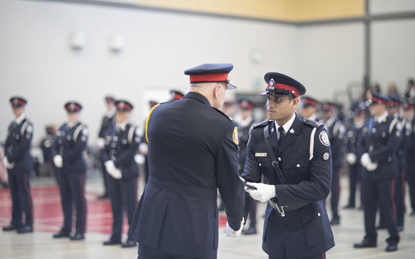Chief James Ramer presents Constable, Ankit Dhabi, his badge. Photo credit: Brent Smyth.