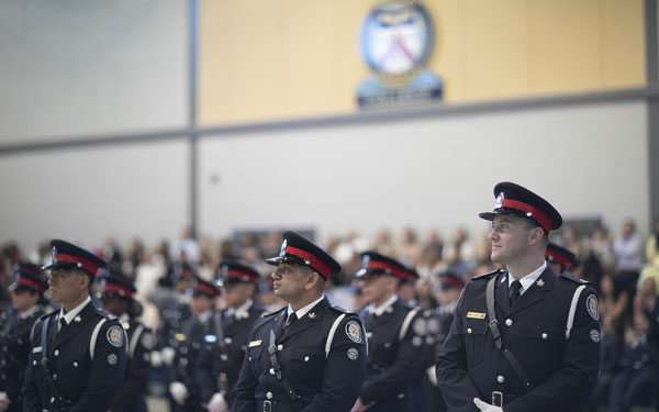 New Police Constables at ease during their graduation ceremony at the Toronto Police College. Photo credit: Brent Smyth.